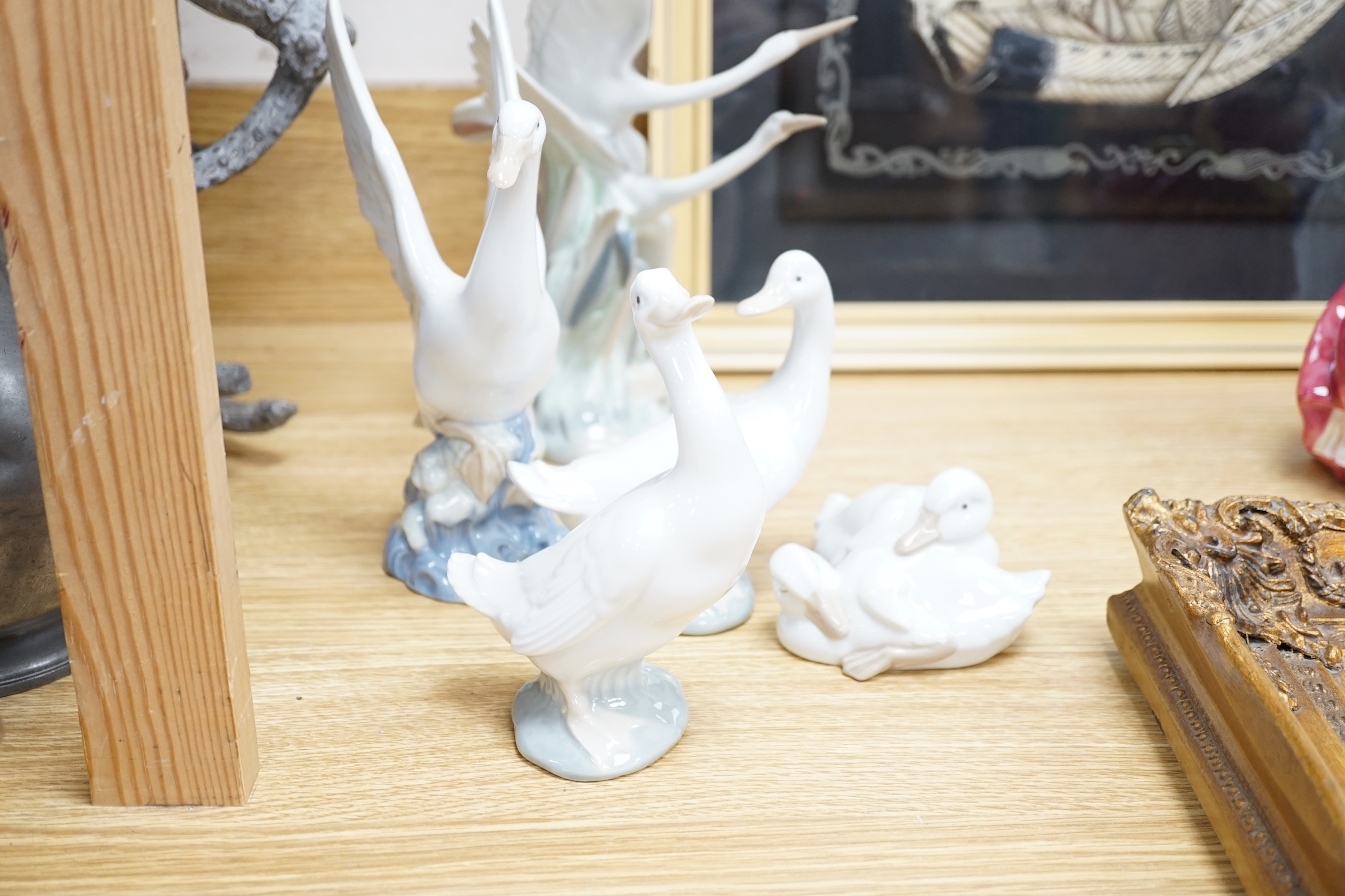 A group of ten Nao figures including a quantity of models of ducks, a cat, a golfer, etc. (all unboxed), tallest 27cm